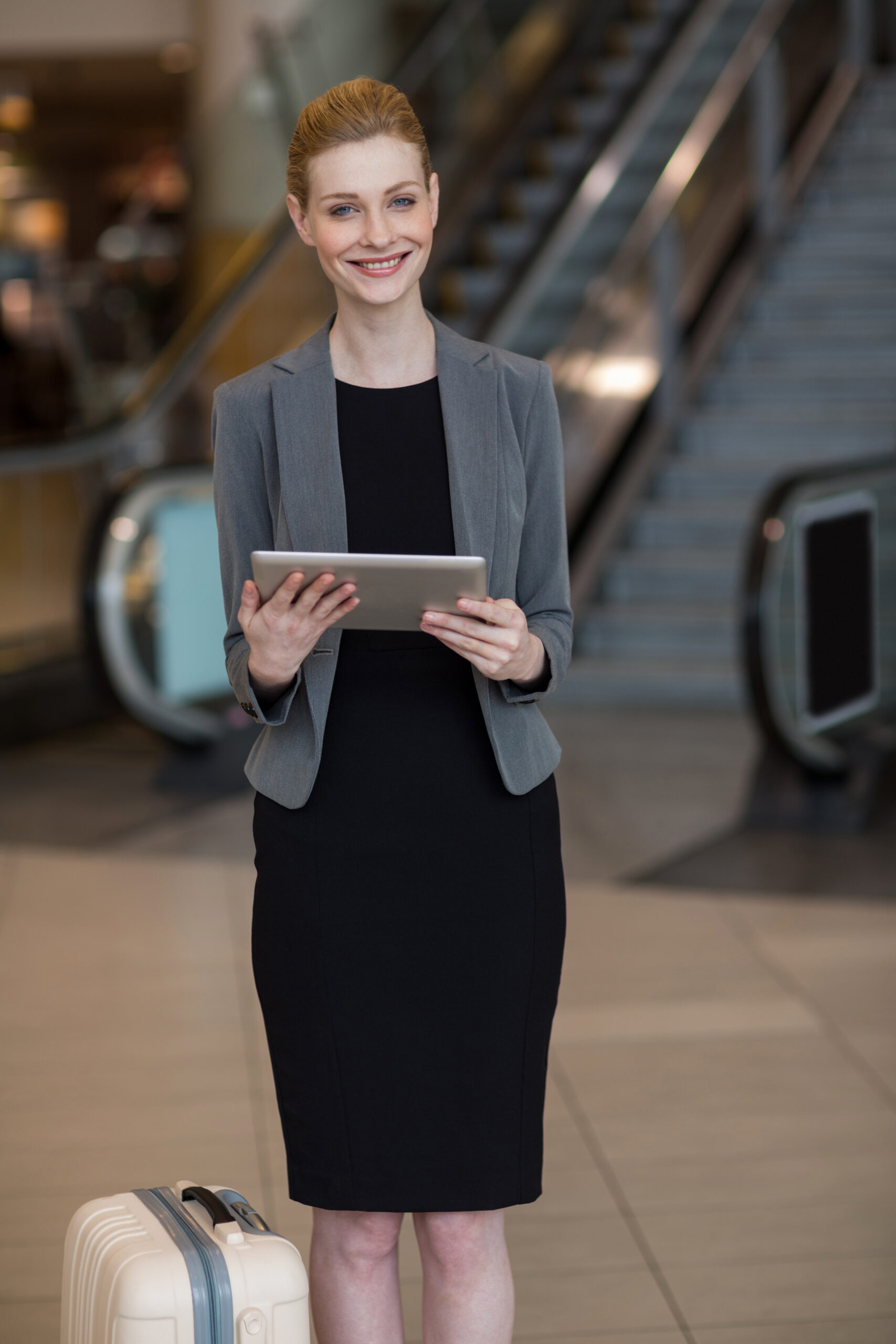 Businesswoman using digital tablet at airport