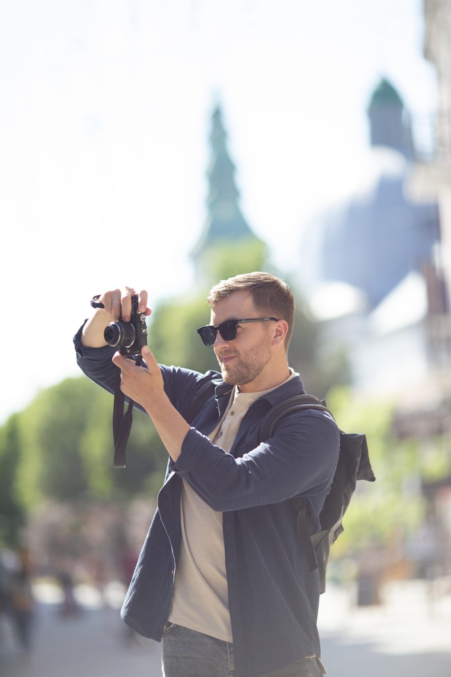 male-traveler-with-camera-local-park