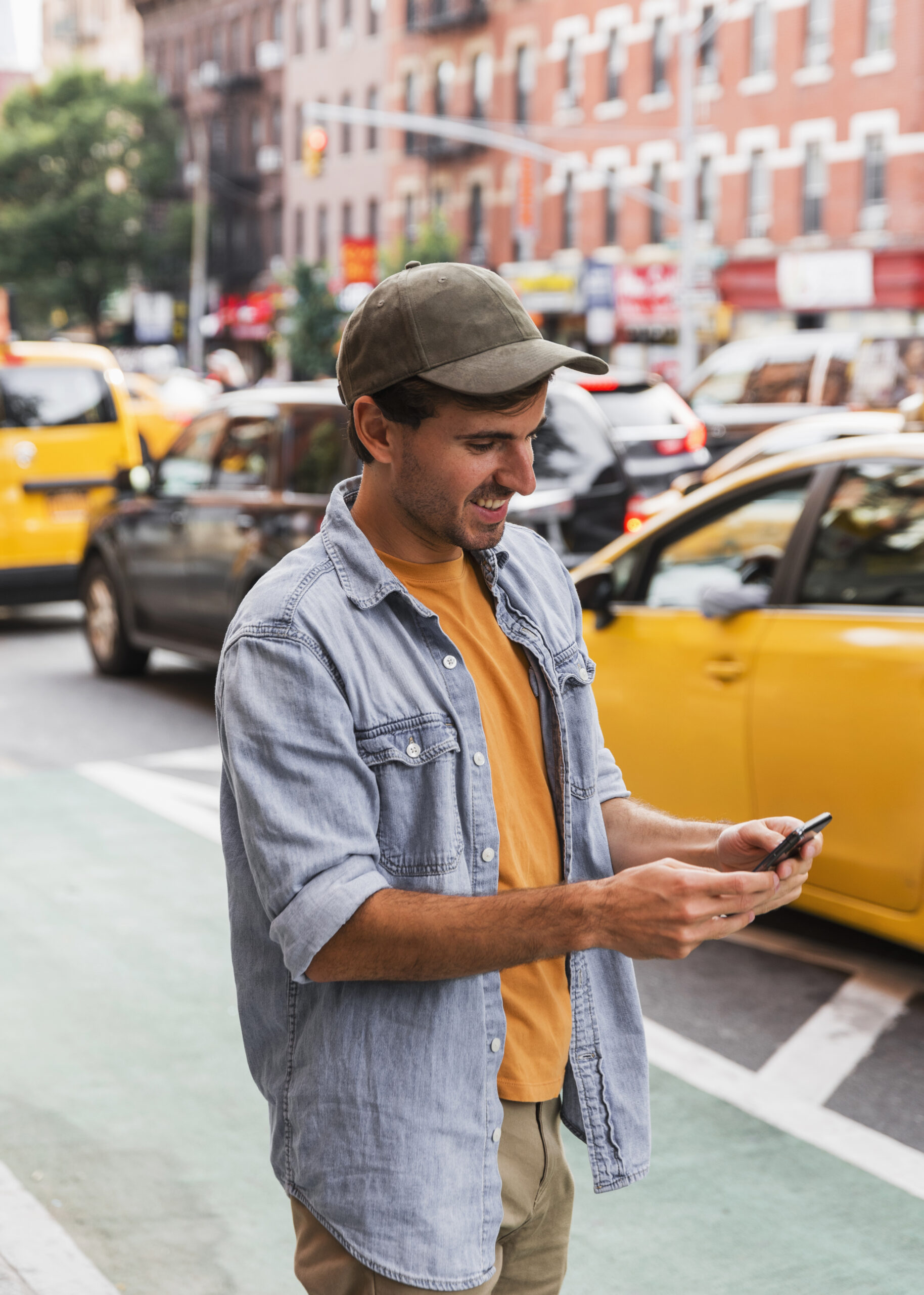 man-with-cap-looking-mobile